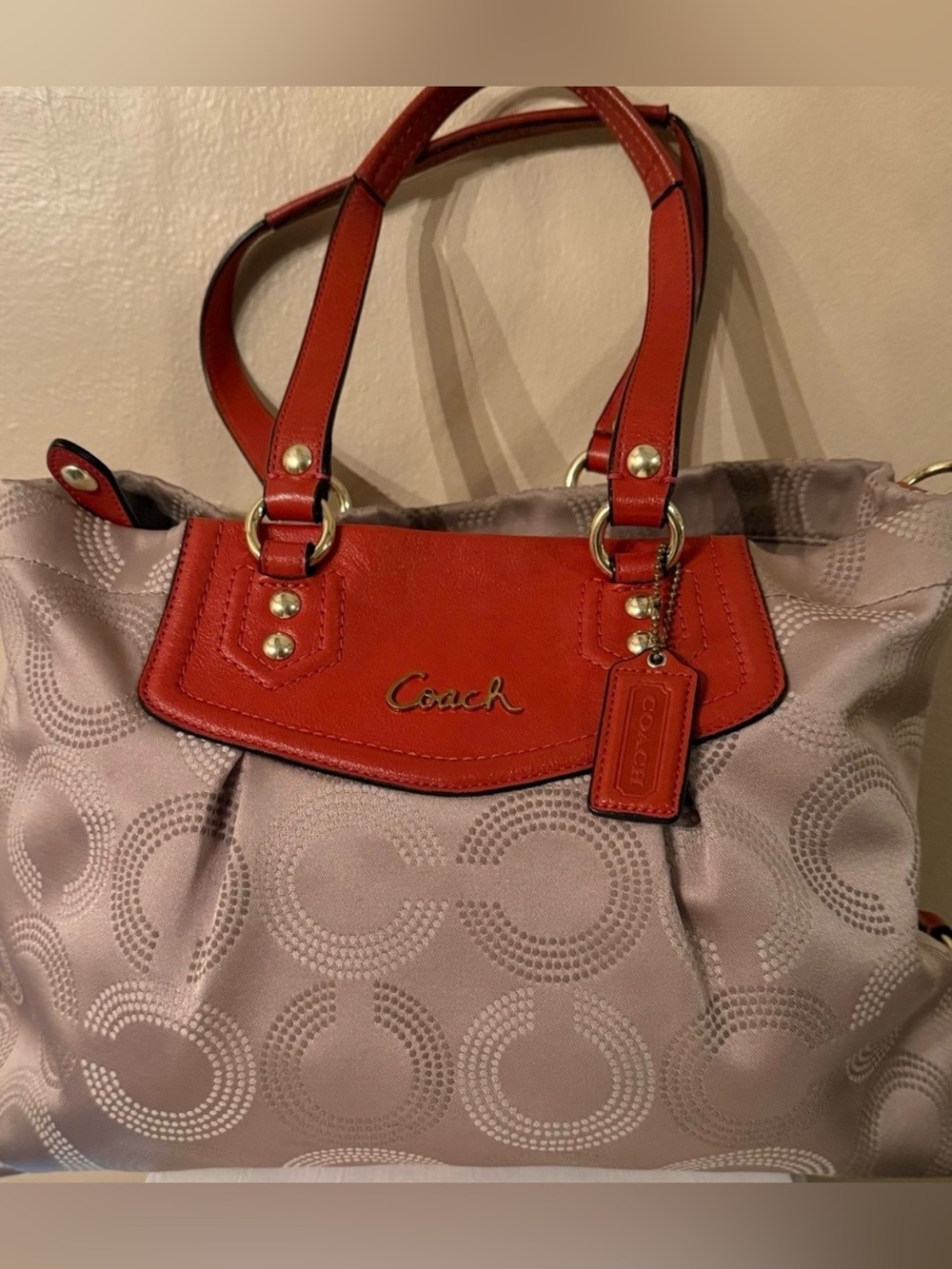 Coach Ashley Dotted Op Art satchel featuring beige sateen fabric and red leather
